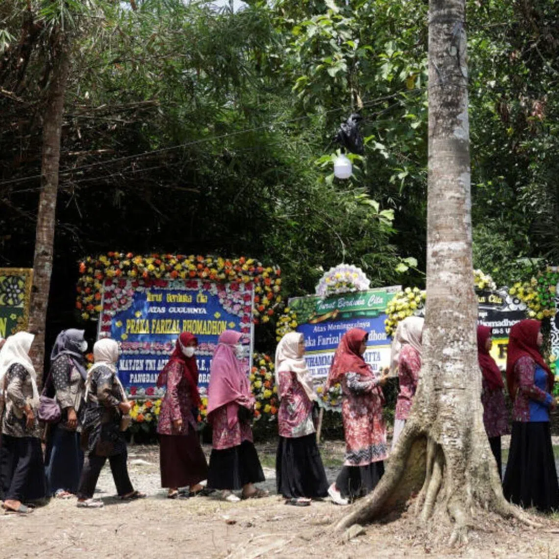 People stand in line to offer condolences for a slain UN peacekeeper, at his parents' house in Kulon Progo regency, Indonesia, on April 1.