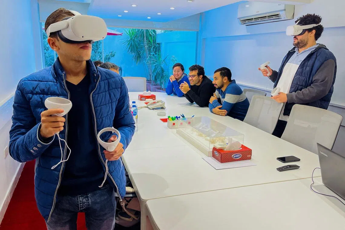 Designers of an Egyptian virtual city touring the metaverse using virtual reality equipment in Cairo, on Dec 5, 2022.
