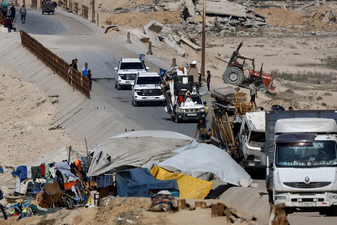 United Nations vehicles drive on a road as displaced Palestinians, fleeing northern Gaza due to an Israeli military operation, move southwards following Israeli forces' orders to leave Gaza City, in the central Gaza Strip October 3, 2025. REUTERS/Mahmoud Issa