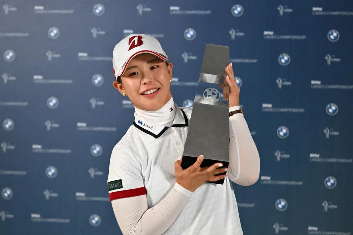A happy Yuri Yoshida celebrating her maiden victory on the LPGA Tour with the BMW Ladies Championship trophy after winning at Pine Beach Golf Links in Haenam, South Korea on Oct 25.