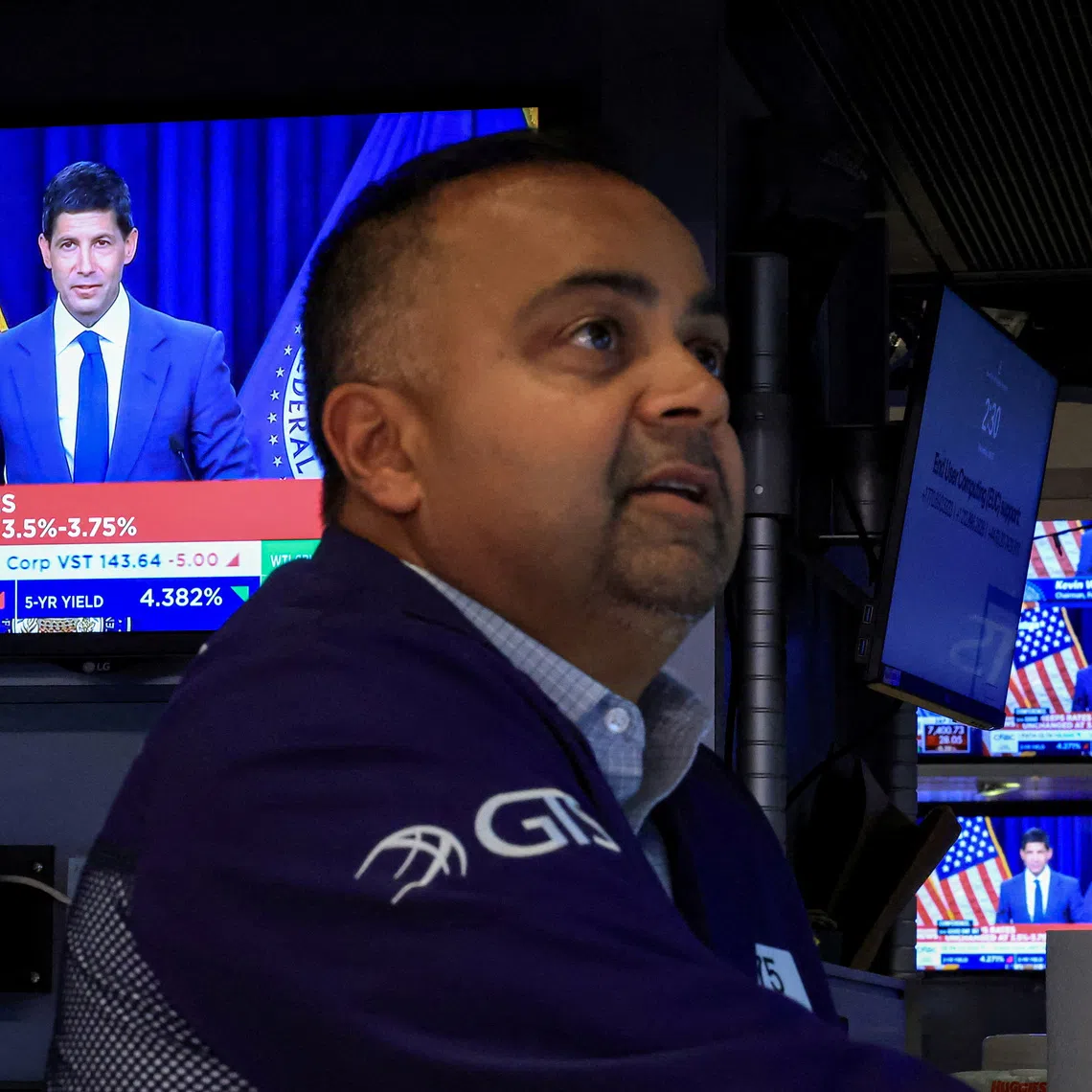 A trader works, as screens broadcast a news conference by US Federal Reserve Chair Kevin Warsh, on the floor of the New York Stock Exchange in New York City.
