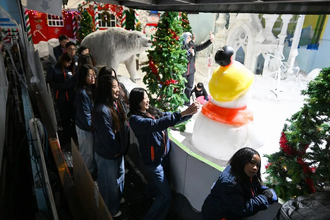 The last few visitors taking a photo while queueing for a five-minute-long Drift on Ice bumper car ride, the only sub-zero bumper car experience on ice in Singapore.