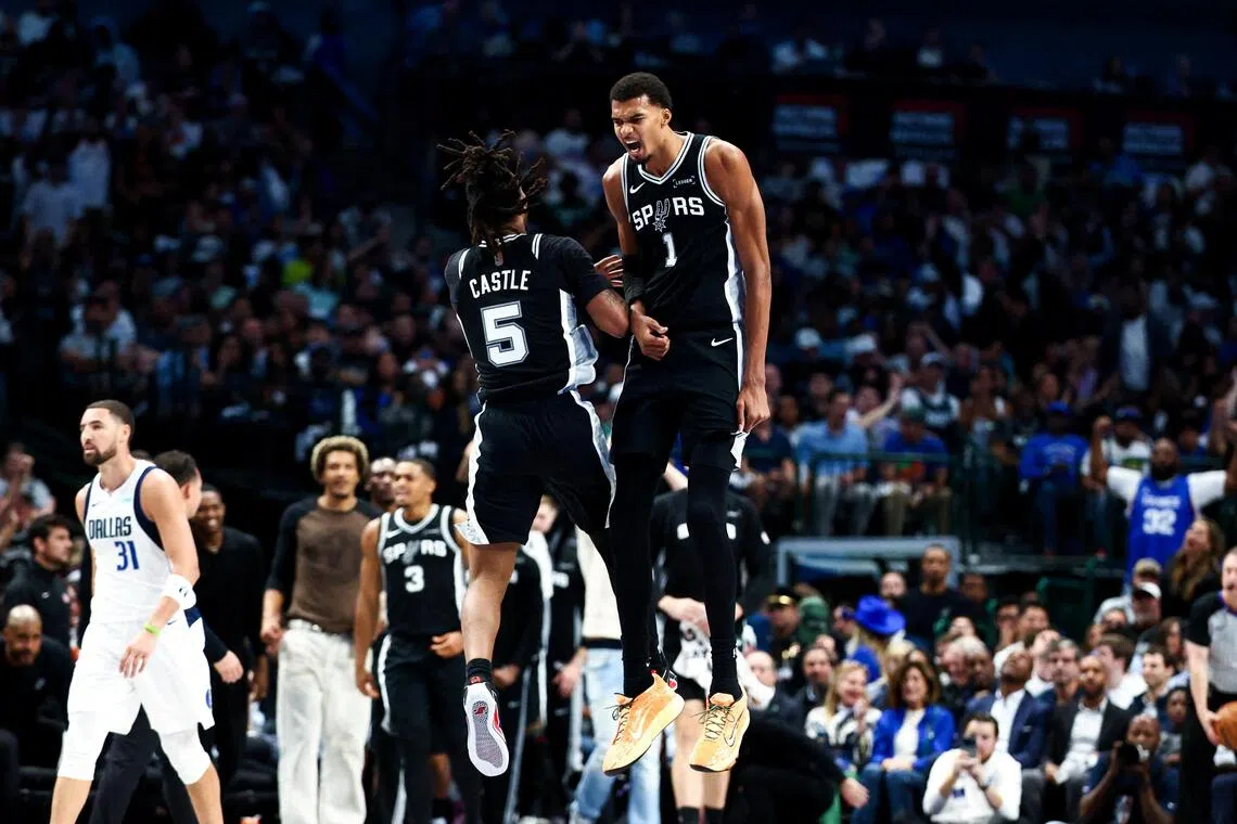 San Antonio Spurs forward Victor Wembanyama celebrates with guard Stephon Castle during the first half  against the Dallas Mavericks at American Airlines Center.