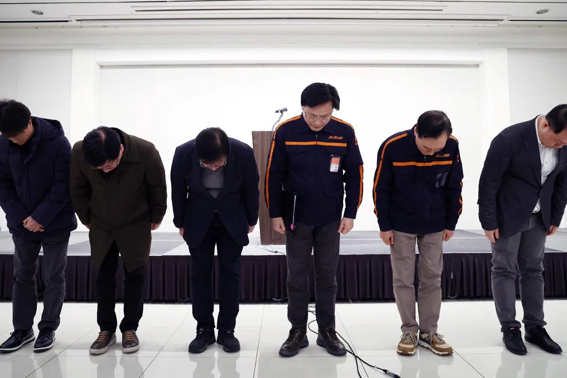 Jeju Air CEO Kim E-bae (3rd-R) and other executive members bow in apology ahead of a briefing in Seoul on December 29, 2024, after a Jeju Air plane carrying 181 people from Thailand to South Korea crashed and burst into flames on arrival at Muan International Airport. A Jeju Air plane carrying 181 people from Thailand to South Korea crashed on arrival, smashing into a barrier and bursting into flames, leaving all but two feared dead. (Photo by YONHAP / AFP) / - South Korea OUT / NO ARCHIVES -  RESTRICTED TO SUBSCRIPTION USE