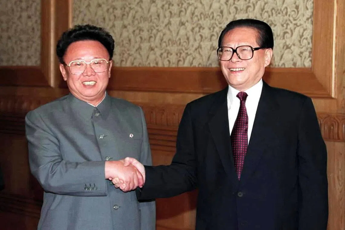 In this file photo taken on June 1, 2000, Chinese President Jiang Zemin (R) shakes hands with North Korean leader Kim Jong-il in Beijing. 