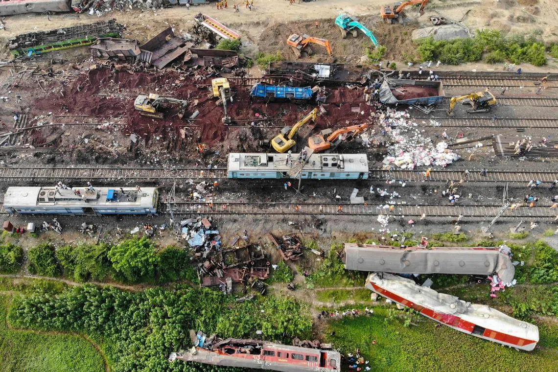 EDITORS NOTE: Graphic content / This aerial view shows damaged carriages at the accident site of a three-train collision near Balasore, about 200 km (125 miles) from the state capital Bhubaneswar in the eastern state of Odisha, on June 4, 2023. Authorities were scrambling on June 4 to understand the cause of a three-train collision in India that killed at least 288 people, claiming that "no one responsible" will be spared. (Photo by Punit PARANJPE / AFP)