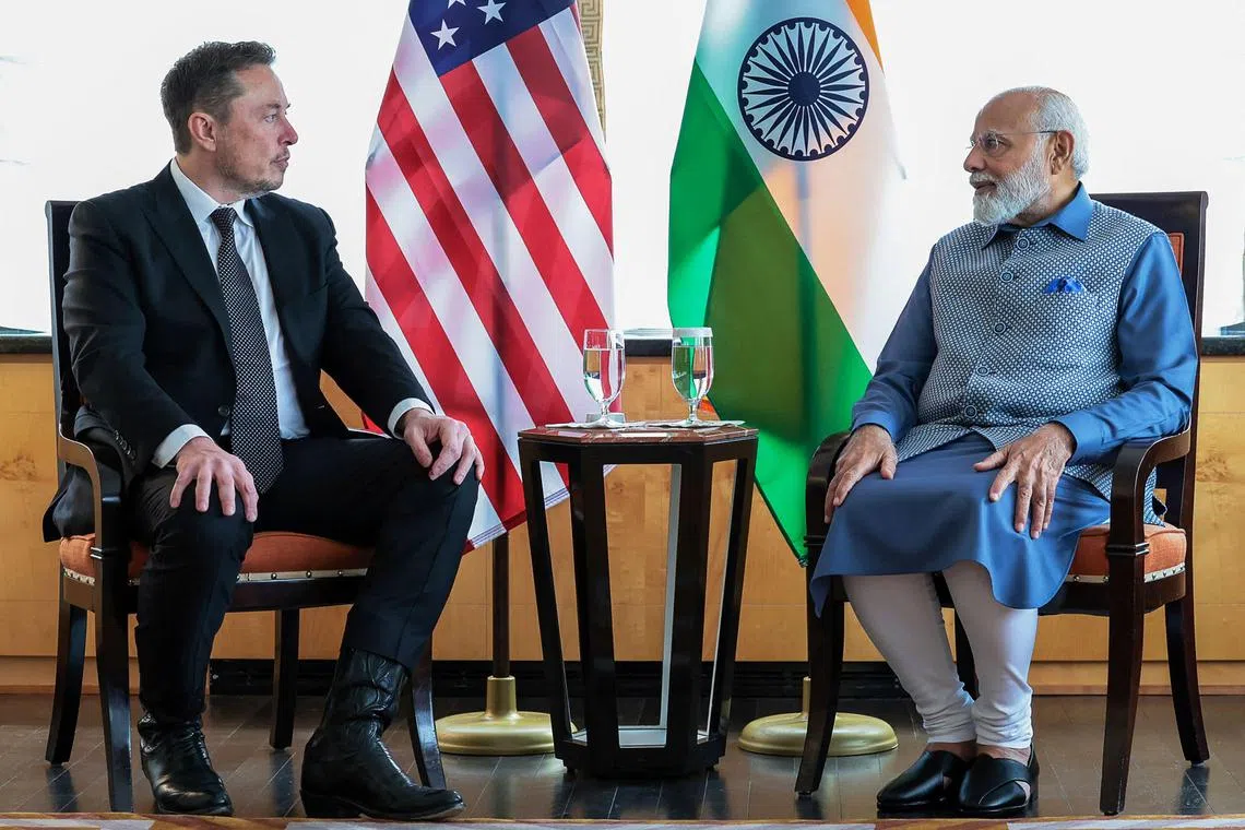 This handout photograph taken on June 20, 2023 and released by the Indian Press Information Bureau (PIB) shows India's Prime Minister Narendra (R) and SpaceX, Twitter and electric car maker Tesla CEO Elon Musk during their meeting in New York. (Photo by PIB / AFP) / RESTRICTED TO EDITORIAL USE - MANDATORY CREDIT "AFP PHOTO / Indian Press Information Bureau (PIB)" - NO MARKETING NO ADVERTISING CAMPAIGNS - DISTRIBUTED AS A SERVICE TO CLIENTS - NO ARCHIVE