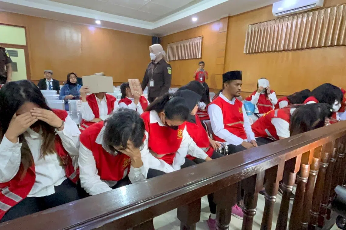 Members of an Indonesian baby-smuggling syndicate at the Bandung District Court in West Java on July 21.