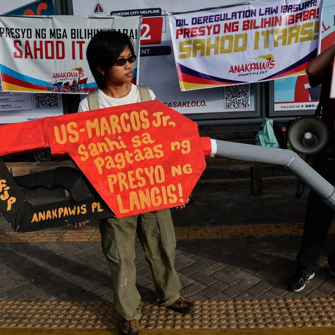 A protester at a rally opposing fuel price hikes and taxes in Quezon City, Metro Manila, on March 19. Patnanungan town's power supply will last from 4pm to 8am daily owing to limited fuel supply.