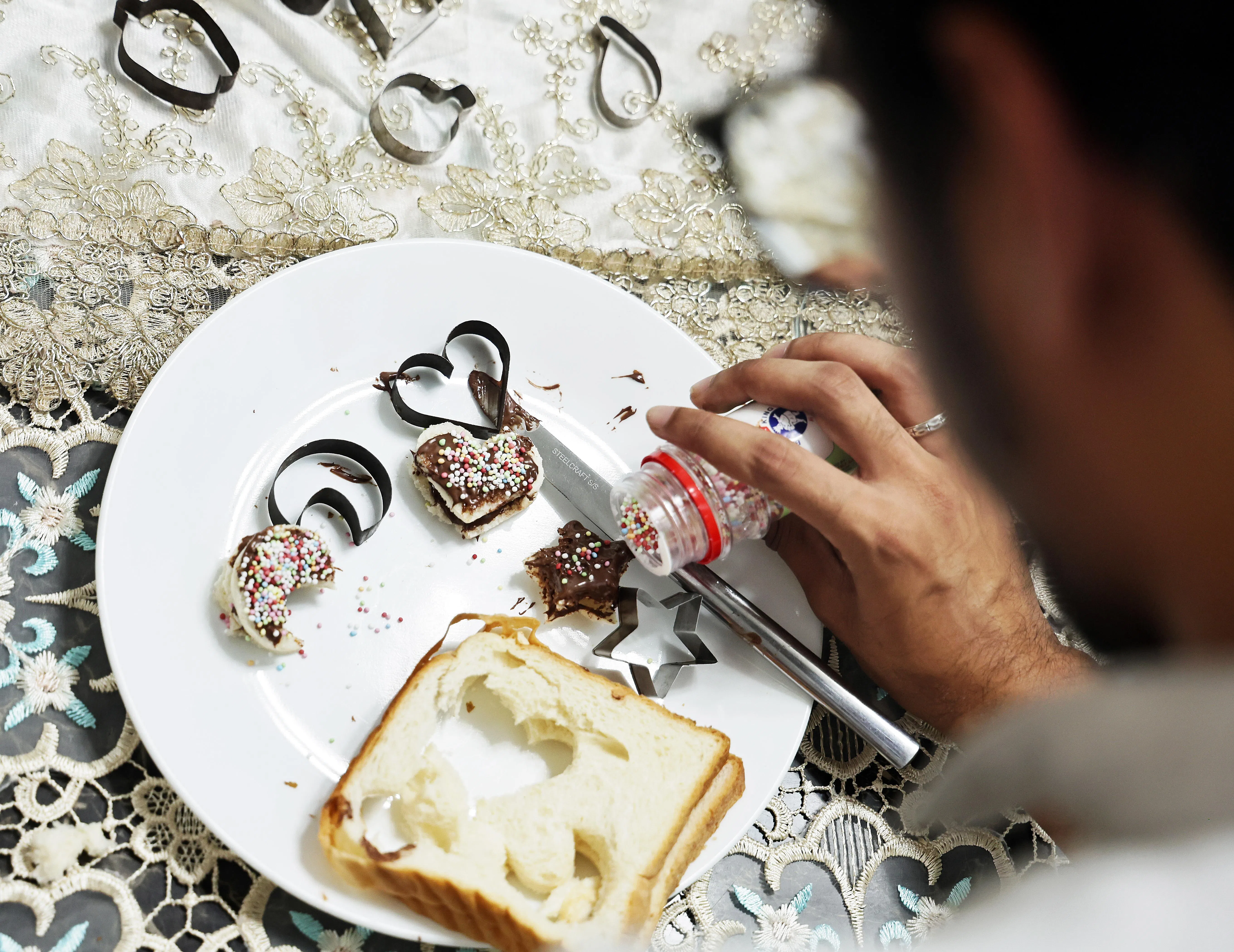 Student Kaiser Ali Mohammed Suhail Suhail adding colourful sprinkles to his food.