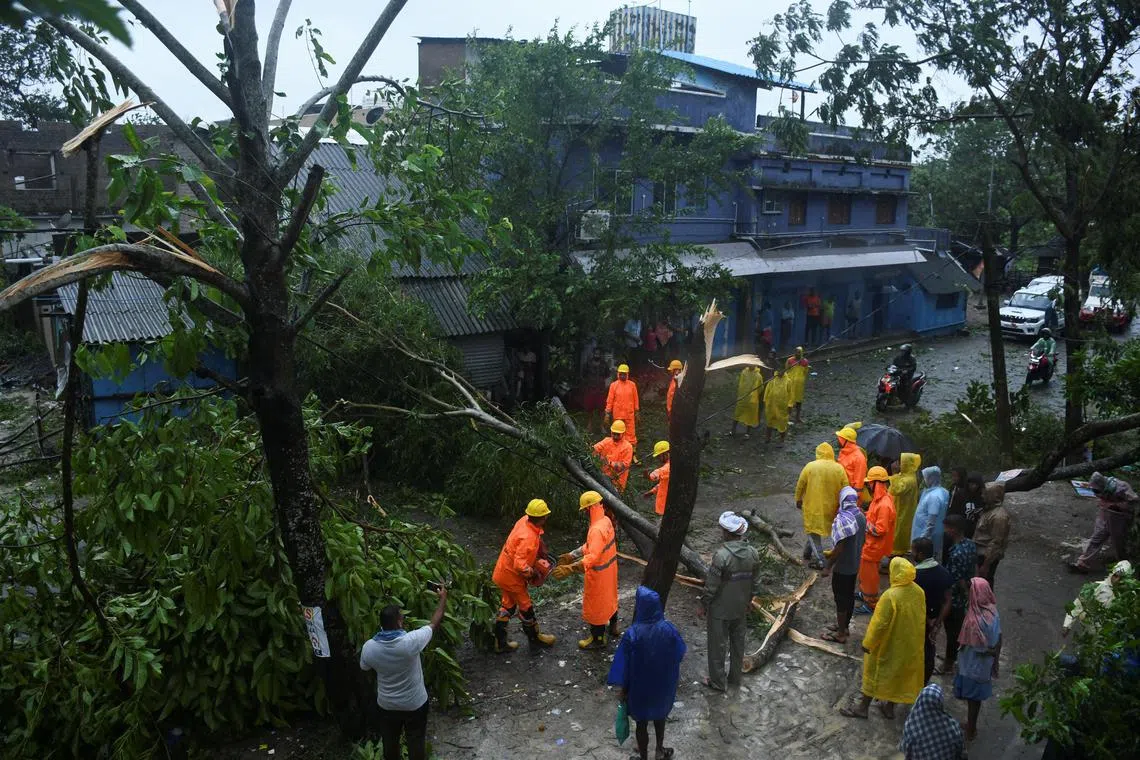National Disaster Response Force (NDRF) personnel clear a tree that fell after cyclone Dana made landfall, in Anantpur village, Balasore district, in the state of Odisha, India, October 25, 2024. REUTERS/Stringer