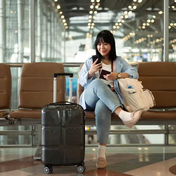 Girl sitting down in airport 