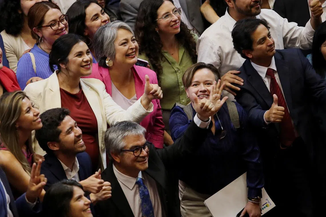 Chile's Labor Minister Jeannette Jara celebrates, along with other ministers and parliamentarians, the approval of a bill to reform the country's private pension system, in the congress in Valparaiso, Chile, January 29, 2025. REUTERS/Rodrigo Garrido