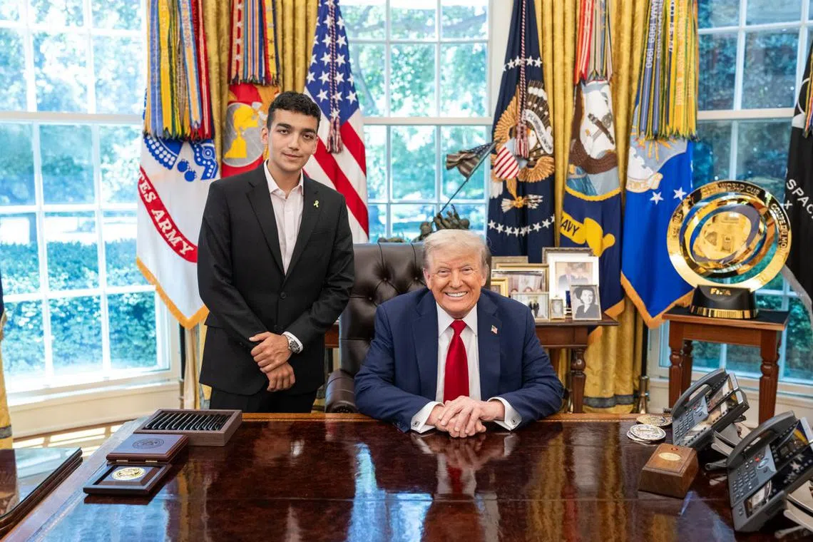 Mr Edan Alexander (right) with Mr Trump at the White House. 