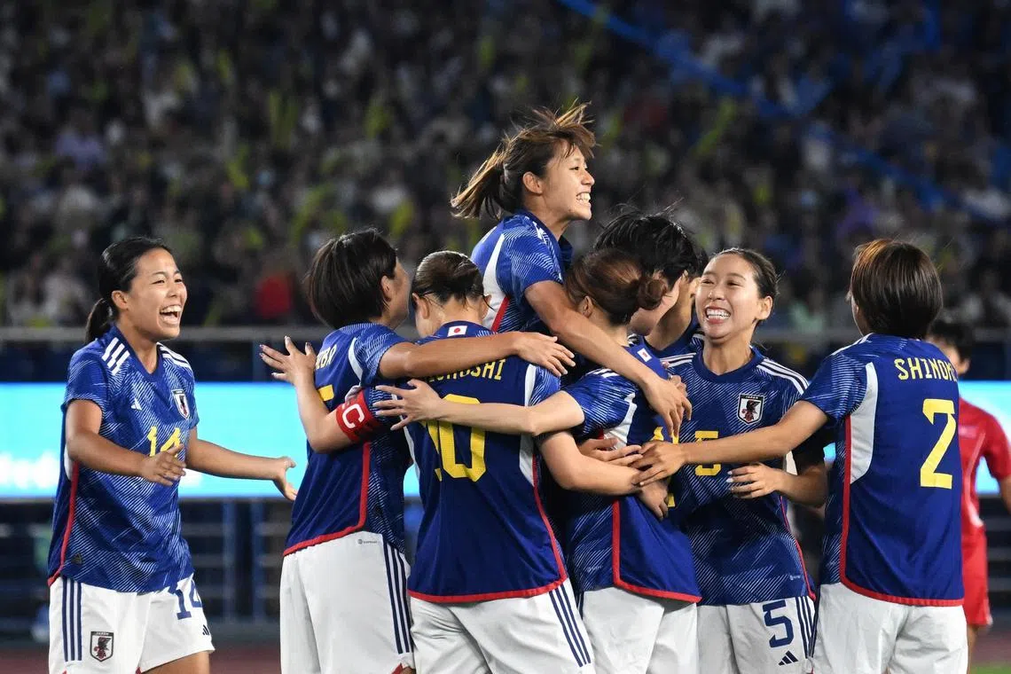 Japanese players celebrate after Yoshino Nakashima scores the first goal in the 4-1 win over North Korea.
