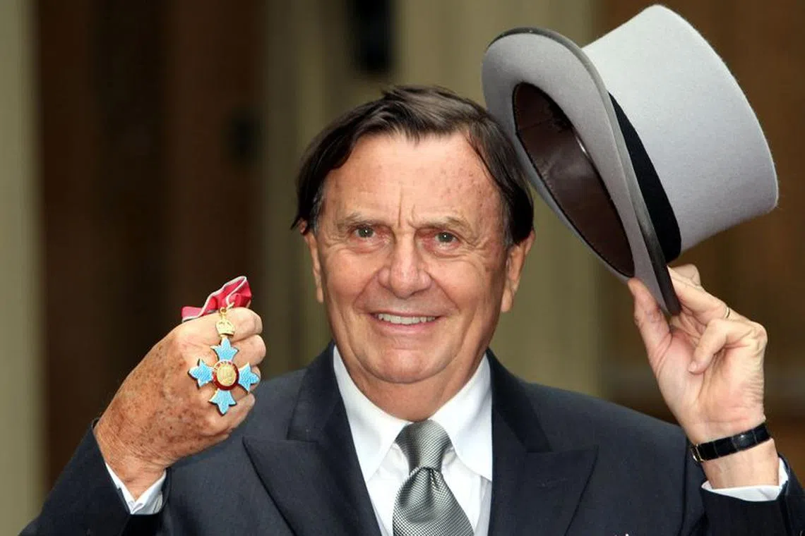 Australia's Barry Humphries poses after receiving his Most Excellent Order of the British Empire from the Queen at Buckingham Palace, London October 10, 2007.    REUTERS/Steve Parsons/Pool/ File photo