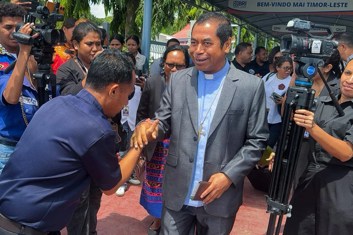 East Timor Cardinal Virgilio Do Carmo Da Silva, 57, greets people at the President Nicolau Lobato International Airport as he leaves for the Vatican, in Dili, East Timor, April 22, 2025. REUTERS/Yuddy Cahya Budiman