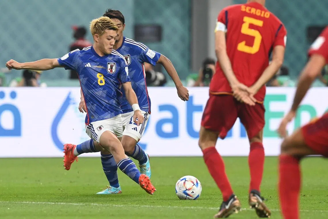 Ritsu Doan (left) scoring Japan's equaliser in their match against Spain on Dec 1. 