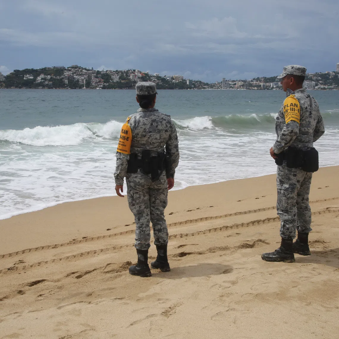 Members of the National Guard stand on a beach as part of the Army, Air Force and National Guard's DN-III disaster relief plan as Category 5 Hurricane Polo strengthens off Mexico's Pacific coast, bringing heavy rain and flooding risks despite a forecast track away from shore, in Acapulco, Mexico, September 22, 2026. REUTERS/Javier Verdin