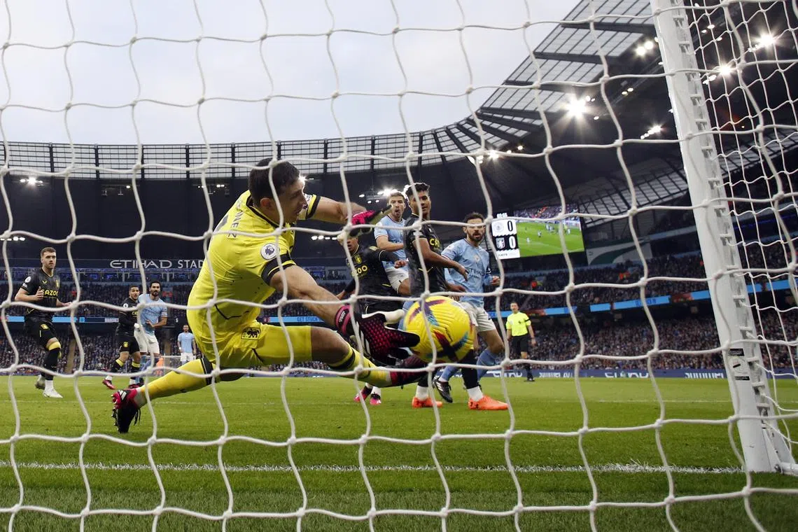 Manchester City's Rodri scores their first goal past Aston Villa's Emiliano Martinez.