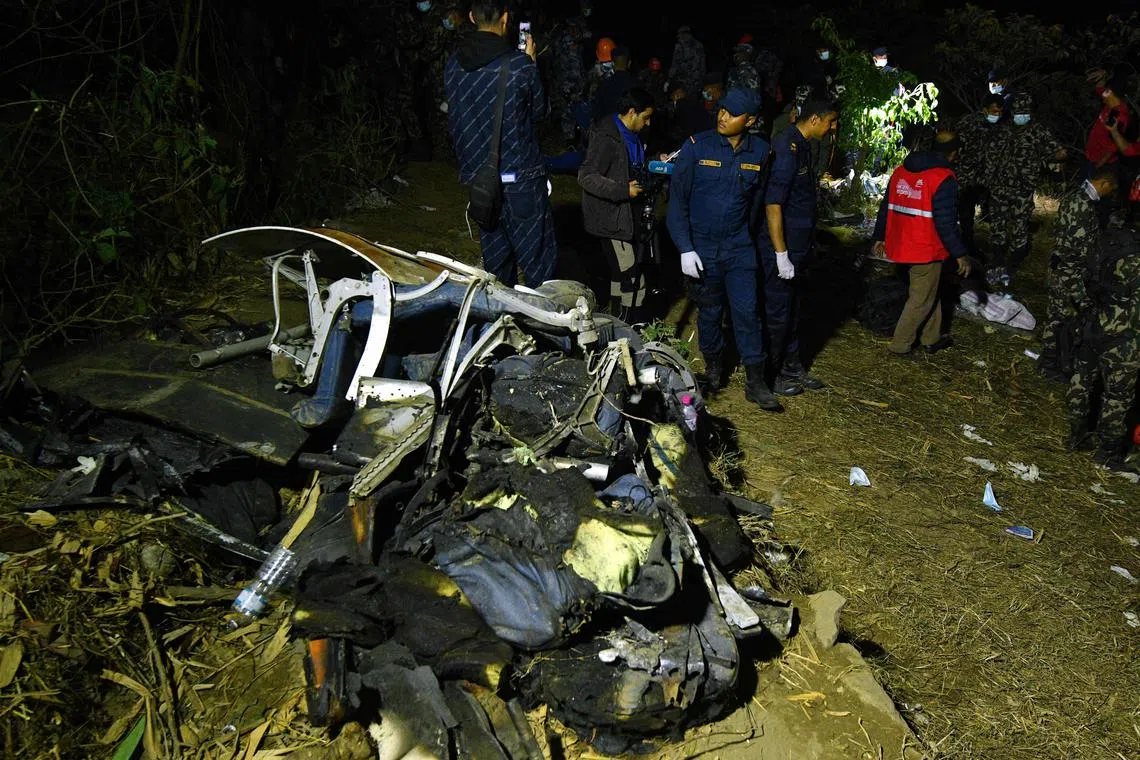 Rescuers inspect the wreckage at the site of a Yeti Airlines plane crash in Pokhara on Jan 15, 2023.