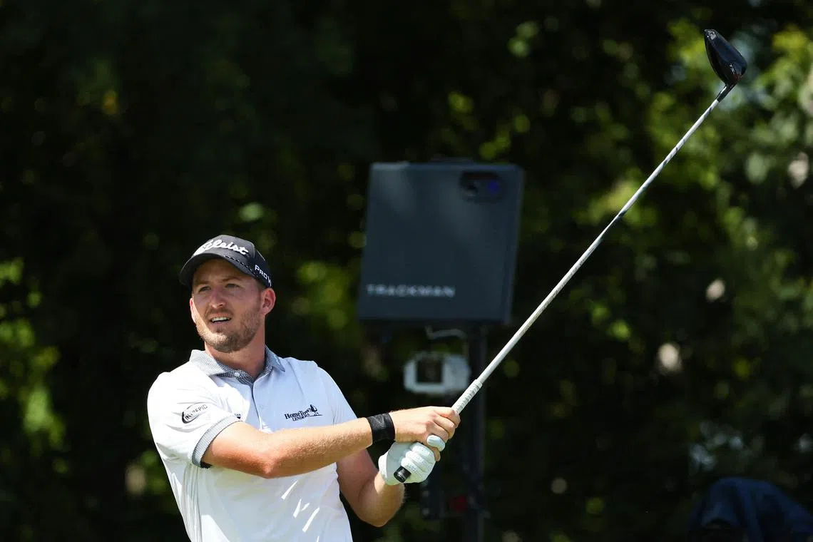 Lee Hodges of the United States watches his tee shot on the 11th tee during the final round of the 3M Open.