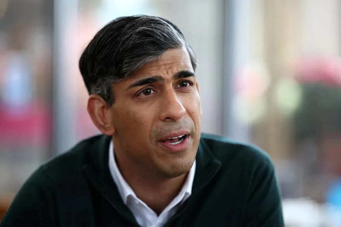FILE PHOTO: British Prime Minister and Conservative Party leader, Rishi Sunak chats with members of the media at a garden centre in Crawley, Britain, June 10, 2024, ahead of a campaign event in the build-up to the UK general election on July 4. HENRY NICHOLLS/Pool via REUTERS/File Photo