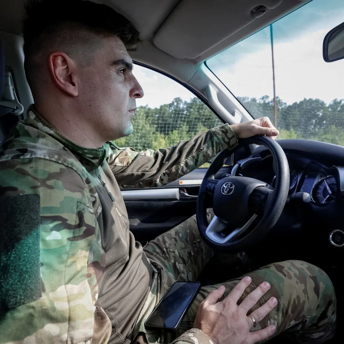Ukrainian commander Vladyslav Polskyi, 29, who rescued injured service members from an unmanned ground vehicle (UGV) and earned nation's highest military honour, the Hero of Ukraine, drives a vehicle, amid Russia's attack on Ukraine, in Kharkiv region, Ukraine, August 20, 2026. REUTERS/Sofiia Gatilova