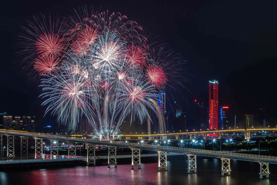 A fireworks display by United Kingdom's team light up the sky near the Macau Tower shorefront during the 31st Macau International Fireworks Contest, in Macau on Oct 11.
