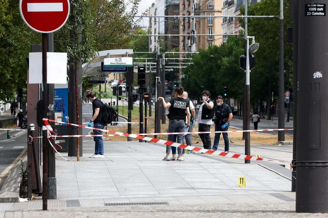 Police officers working at the site of the knife attack, in Paris’ 17th arrondissement, on July 27.