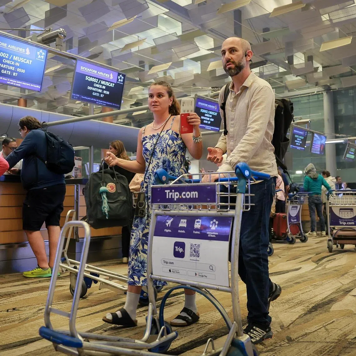 Jeremie Berard, 36, and Joana Goncalves, 31, check in for SQ8002 to Muscat, Oman on March 8, 2026.