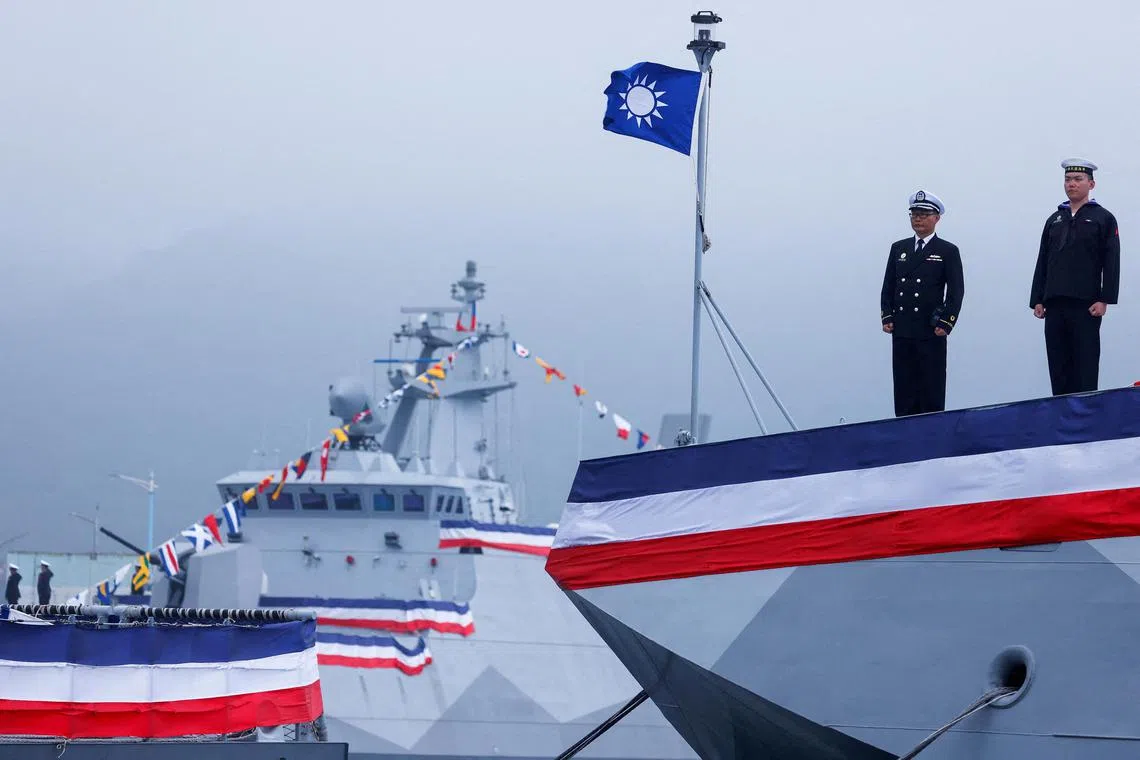 Navy personnel stand guard during the delivery ceremony of six made-in-Taiwan Tuo Chiang-class corvettes at a port in Yilan, Taiwan.
