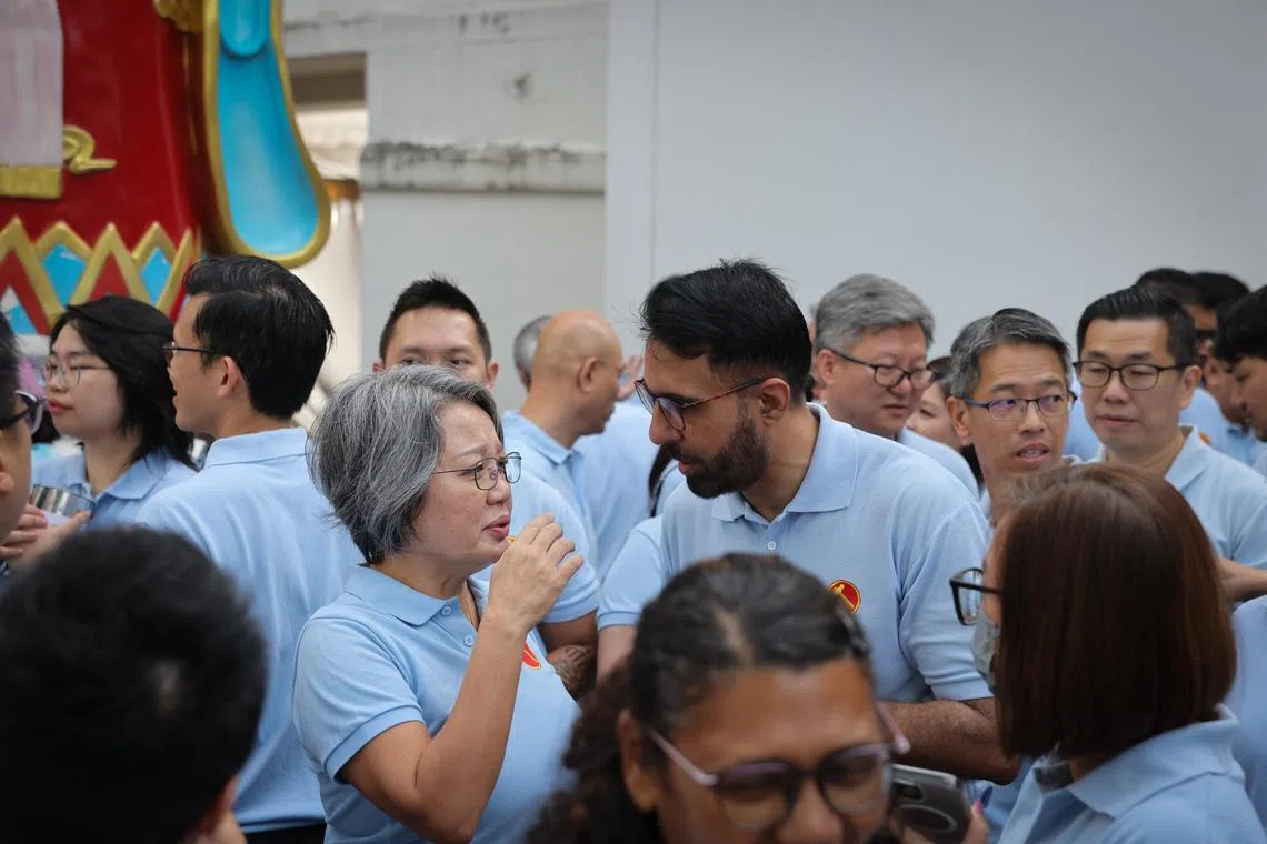 Workers' Party chairwoman Sylvia Lim (centre, left) speaking to Mr Pritam Singh at the party's community outreach event in Serangoon North on Jan 18.