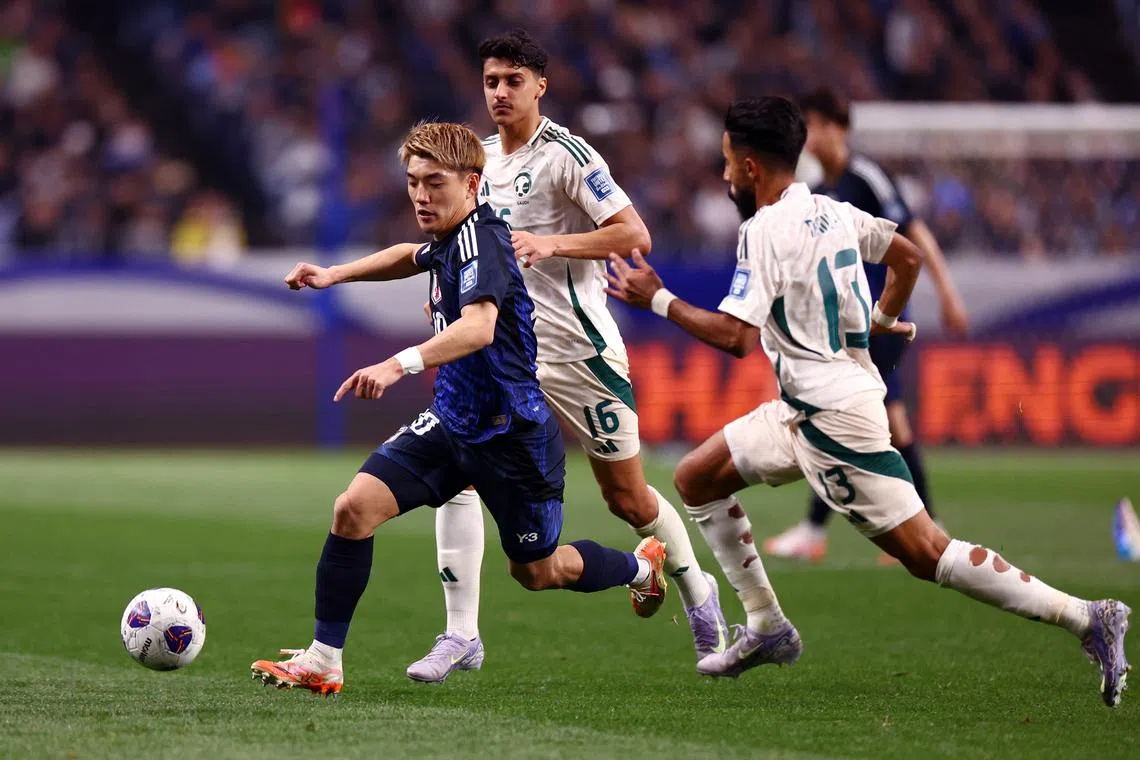 FILE PHOTO: Soccer Football - World Cup - AFC Qualifiers - Third Round - Group A - Japan v Saudi Arabia - Saitama Stadium, Saitama, Japan - March 25, 2025 Japan's Ritsu Doan in action with Saudi Arabia's Nawaf Boushal and Faisel Al-Ghamdi REUTERS/Issei Kato/File Photo