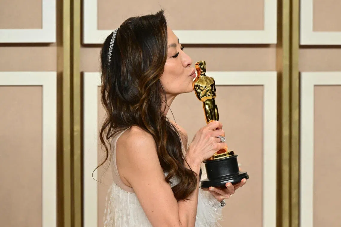Malaysian actress Michelle Yeoh poses with the Oscar for Best Actress for her performance in Everything Everywhere All At Once. She is the first Asian woman to clinch the honour.