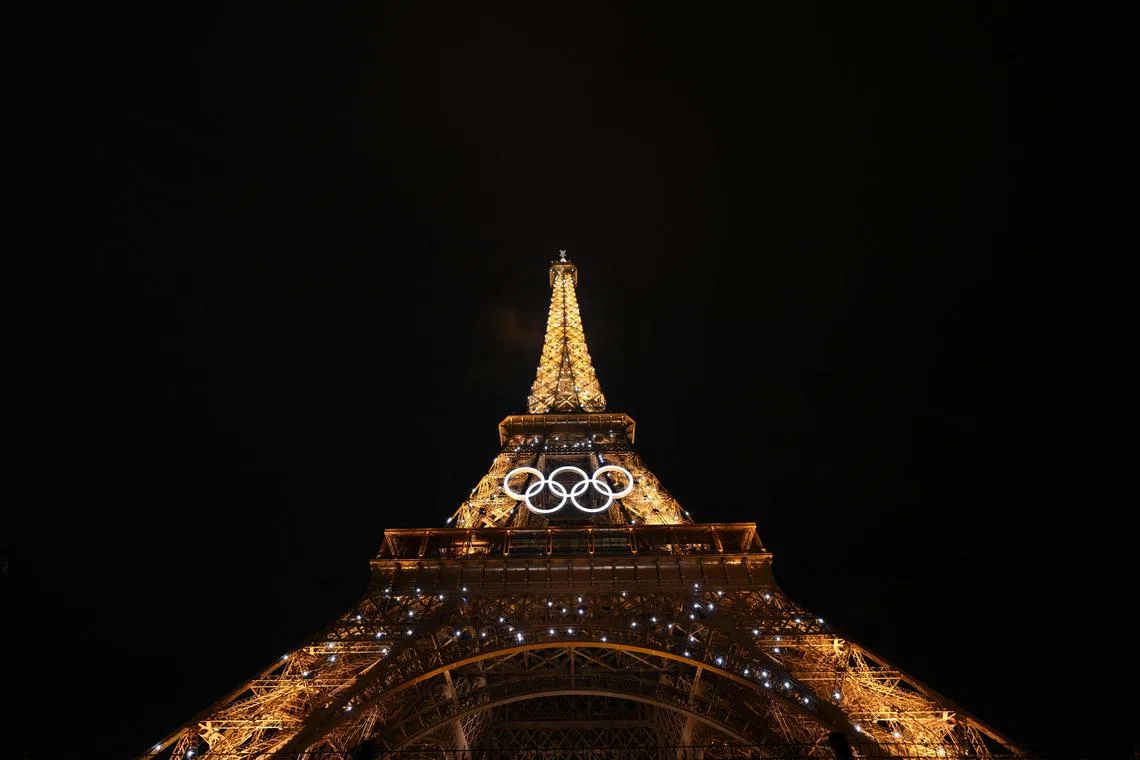 (FILES) This photograph taken on July 26, 2024 shows the Eiffel Tower with the Olympics Rings after the opening ceremony of the Paris 2024 Olympic Games in Paris. Will the Eiffel Tower be adorned with the Olympic rings ad vitam aeternam? The Paris mayor's plan to preserve the ‘historic moment’ of the Olympic and Paralympic Games has raised an outcry from heritage conservationists and opponents of Anne Hidalgo. (Photo by Luis ROBAYO / POOL / AFP)