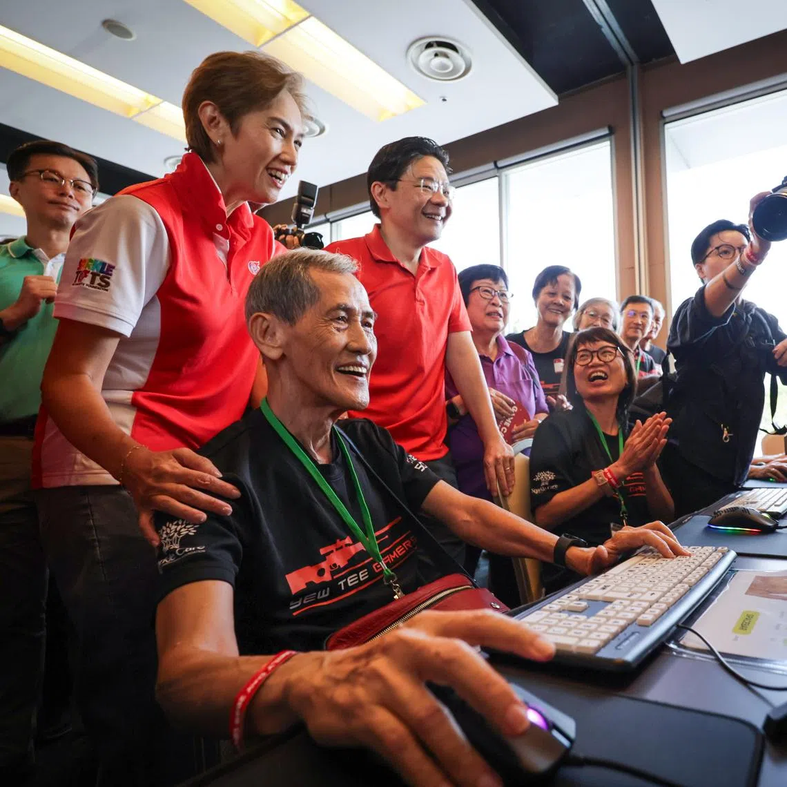 Prime Minister Lawrence Wong and Minister for Digital Development and Information Josephine Teo, with retirees Chong Hock Loo, 75, and Shirley Tan, 68, during the PCF Family Day event on July 13.