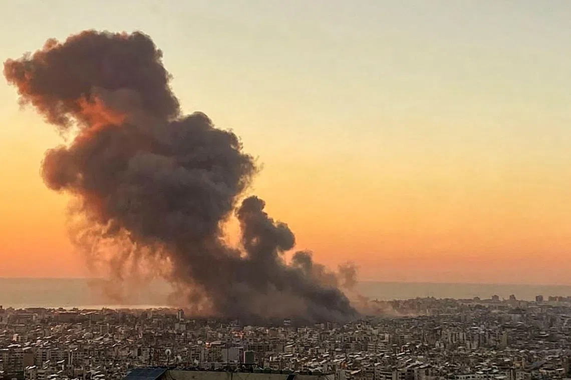 Smoke rising above Beirut's southern suburbs during an Israeli strike on Sept 27, 2024. 