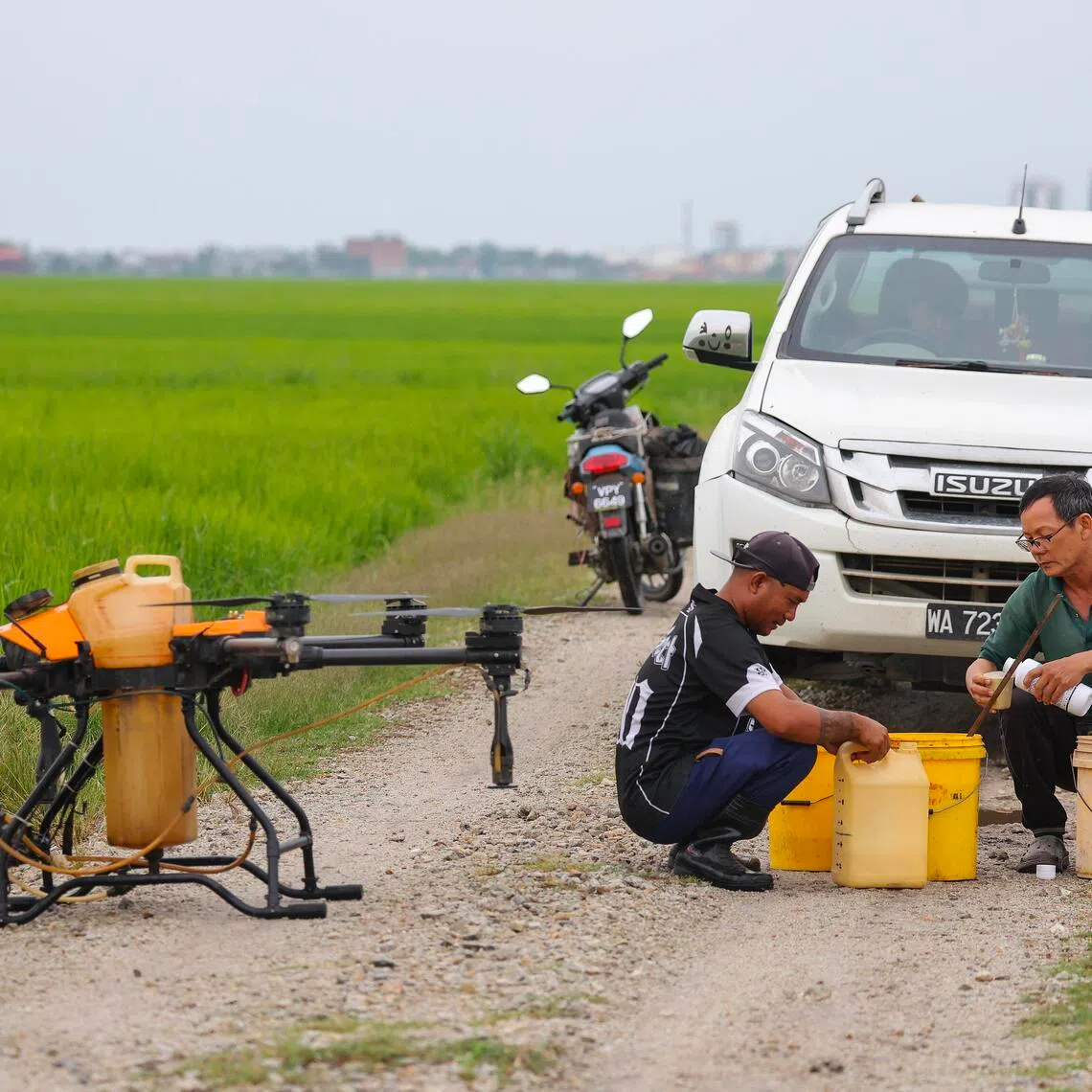 Workers prepare a drone to spray fertiliser on a paddy field in Sabak Bernam, Selangor. Conflict in the Middle East has driven up energy prices, raising the cost of transport and fertilisers.