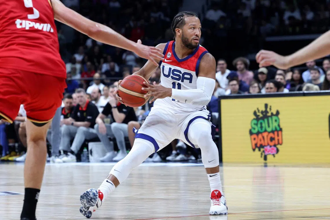 United States Jalen Brunson (C) looks to pass during the Basketball Showcase friendly match between the USA and Germany at the Etihad Arena in Abu Dhabi on August 20, 2023. (Photo by Giuseppe CACACE / AFP)