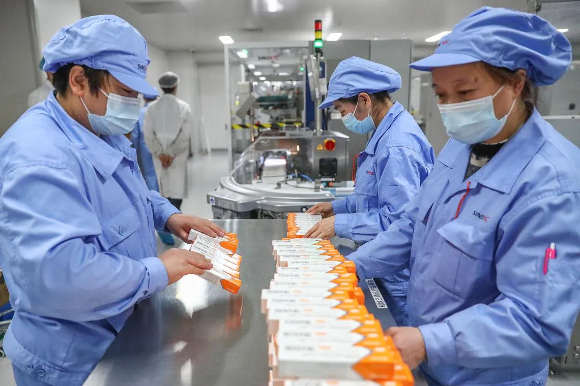 Workers working at a Sinovac Covid-19 vaccine production line in Beijing in 2021. So far, the biotech industry is relatively insulated from Mr Trump’s tariffs.