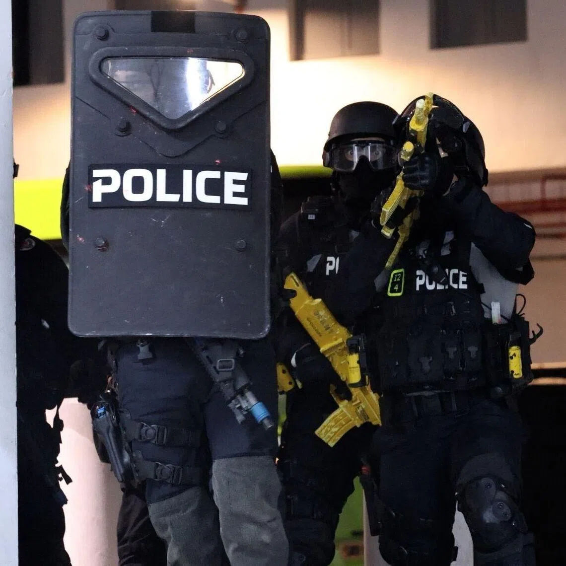 The police's Special Operations Command arriving in response to a simulated terrorist scenario in a shopping mall at the Home Team Tactical Centre.
