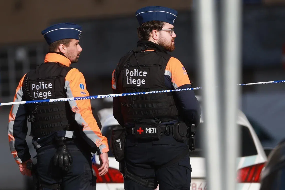 Police officers secure the area outside a synagogue after an explosion in Liege, Belgium, on March 9.