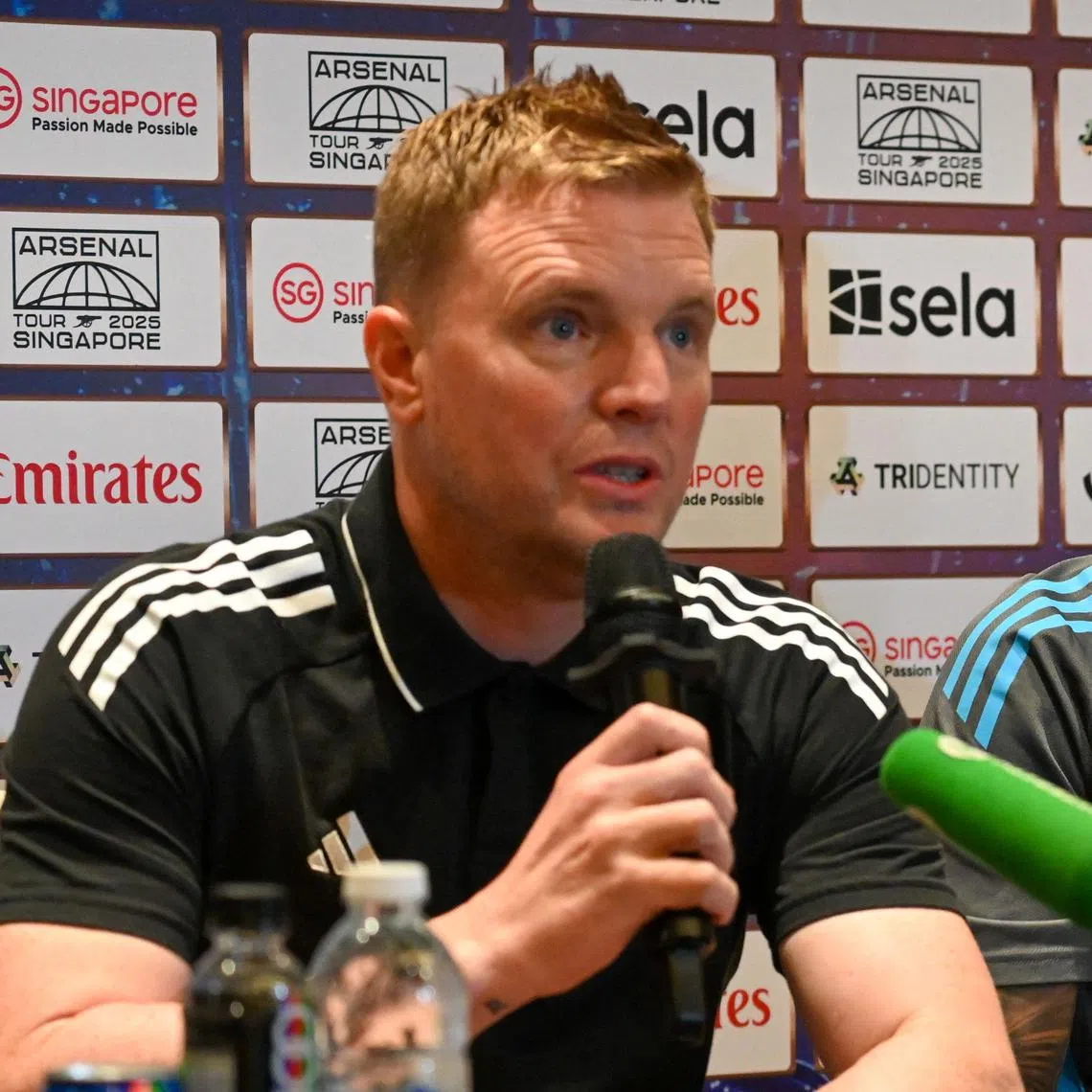 Newcastle’s manager Eddie Howe (L) and captain Bruno Guimaraes attend a press conference ahead of their pre-season football match against Arsenal at the National Stadium in Singapore on July 26, 2025. (Photo by Roslan RAHMAN / AFP)