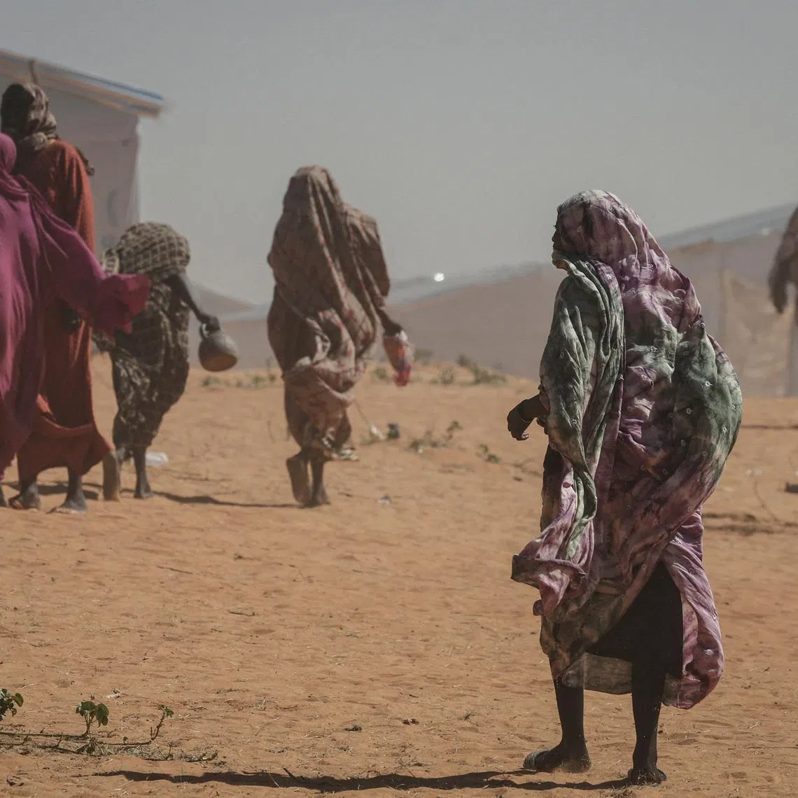 FILE PHOTO: Sudanese refugee women walk at the Tulum refugee camp, amid ongoing conflict in Sudan between the paramilitary Rapid Support Forces (RSF) and the Sudanese army, in Wadi Fira province, eastern Chad, November 30, 2025. REUTERS/Amr Abdallah Dalsh/File Photo