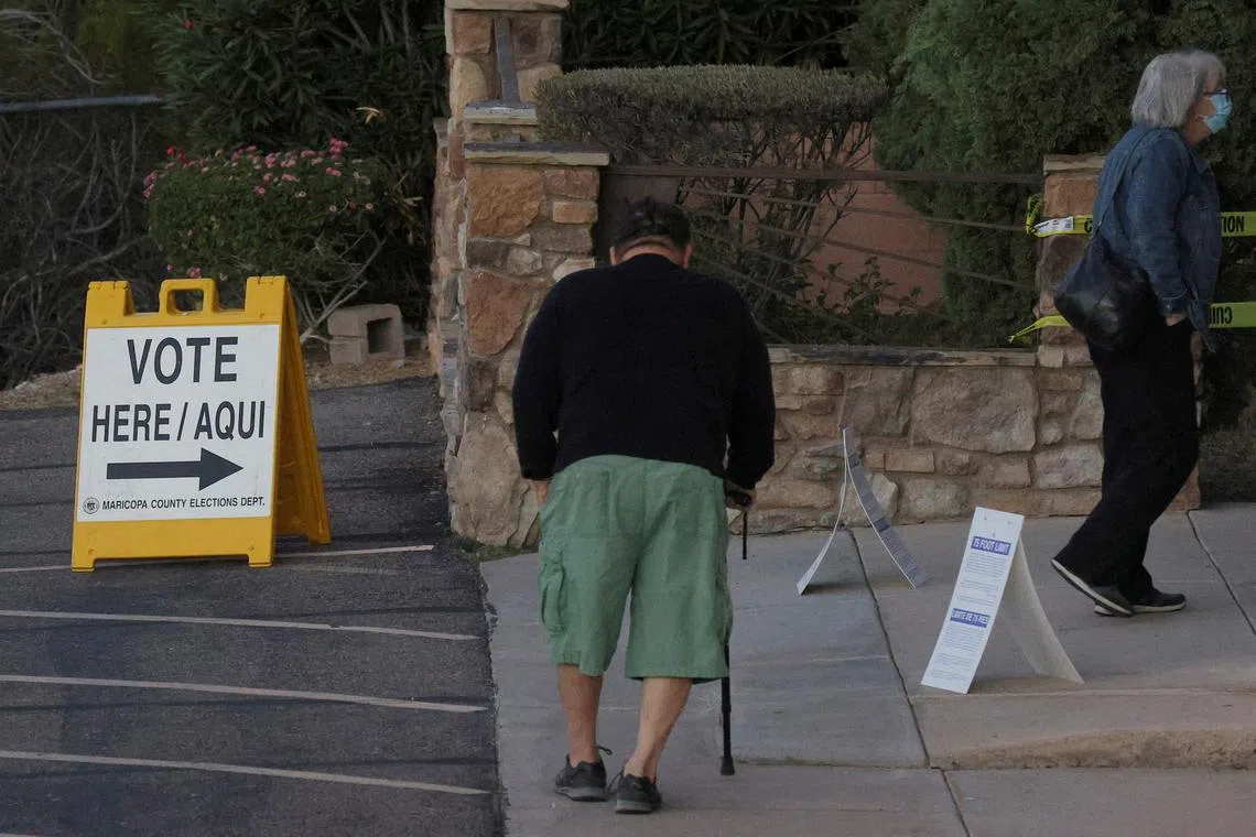 Voters arrive to cast their ballots in Phoenix, Arizona, on Nov 8, 2022.