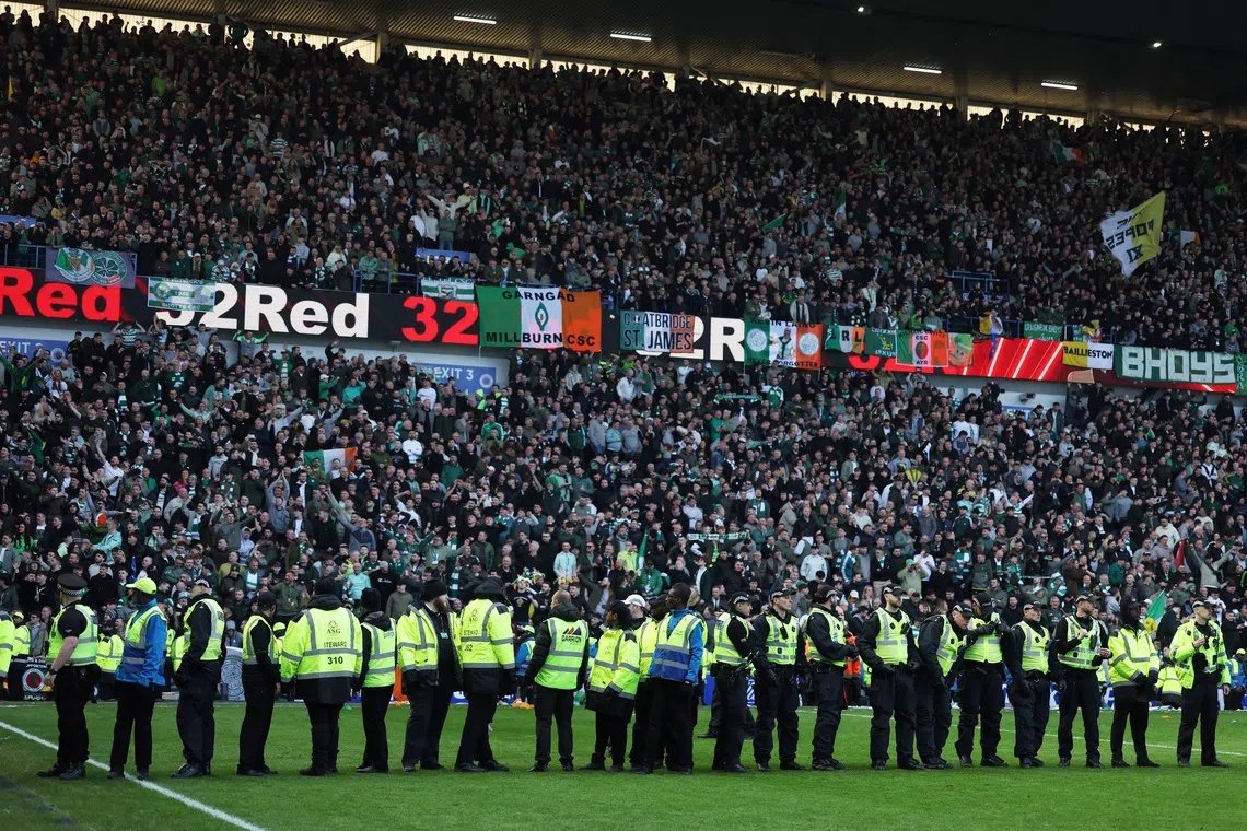 FILE PHOTO: Soccer Football - Scottish League Cup - Quarter Final - Rangers v Celtic - Ibrox, Glasgow, Scotland, Britain - March 8, 2026 General view of police officers on the pitch after the match REUTERS/Russell Cheyne/File Photo