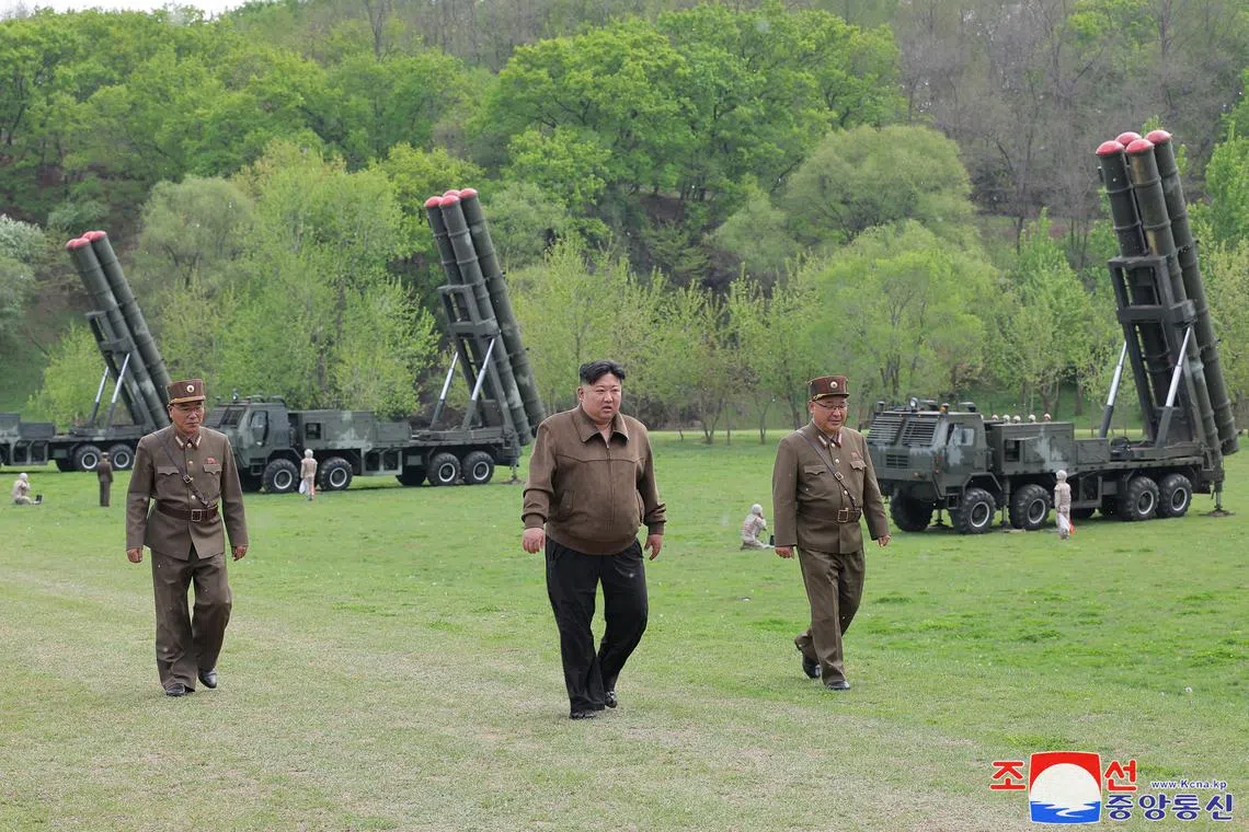 North Korean leader Kim Jong Un (C) overseeing a simulated nuclear counterattack drill at an undisclosed location in North Korea on April 22, 2024.