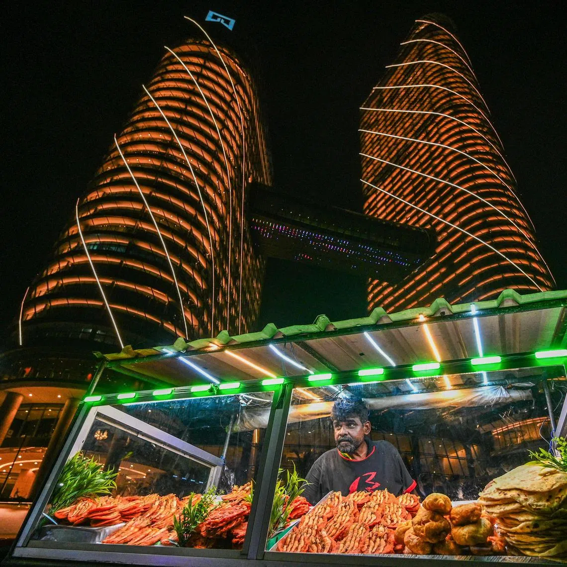 TOPSHOT - A street vendor sells prawns at the Galle Face sea-front promenade in Colombo on March 15, 2024. (Photo by Ishara S. KODIKARA / AFP)
