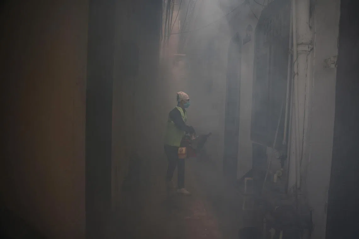 FILE PHOTO: A health worker fumigates interiors of a house in a residential neighbourhood to prevent the spread of mosquito-borne diseases following the rise in dengue cases in New Delhi, India, September 22, 2022. REUTERS/Anushree Fadnavis/File Photo